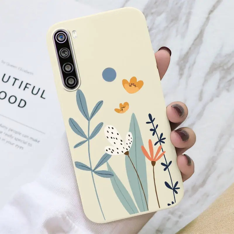 a hand holding a phone case with a flower design