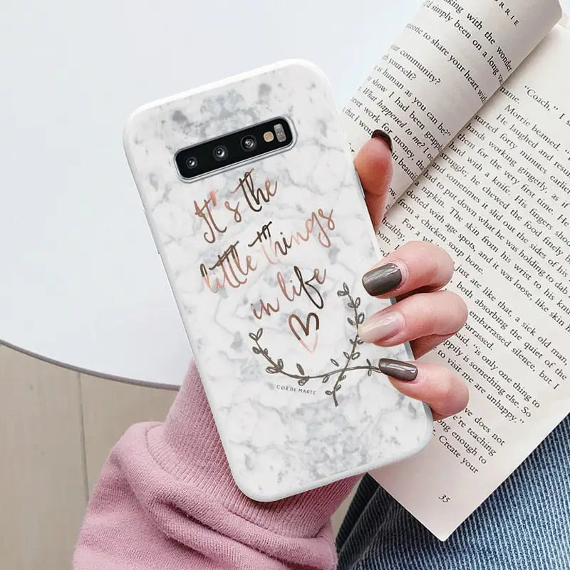 someone holding a phone case with a quote on it