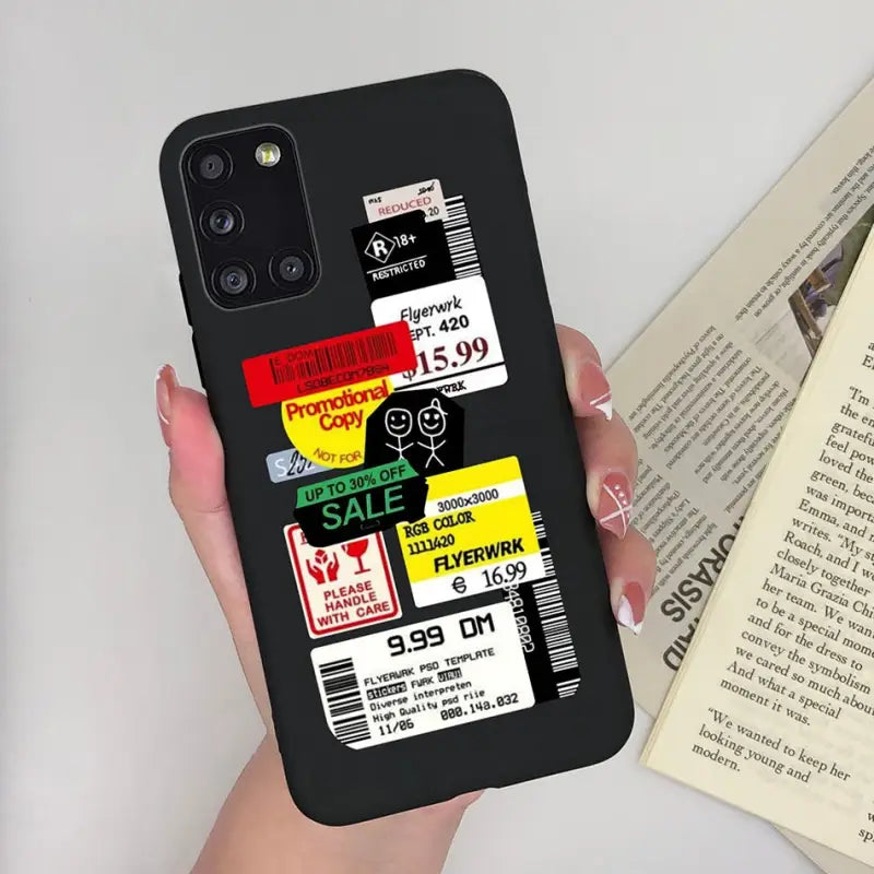 a woman holding a phone case with a book