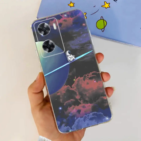 a hand holding a phone case with a space theme