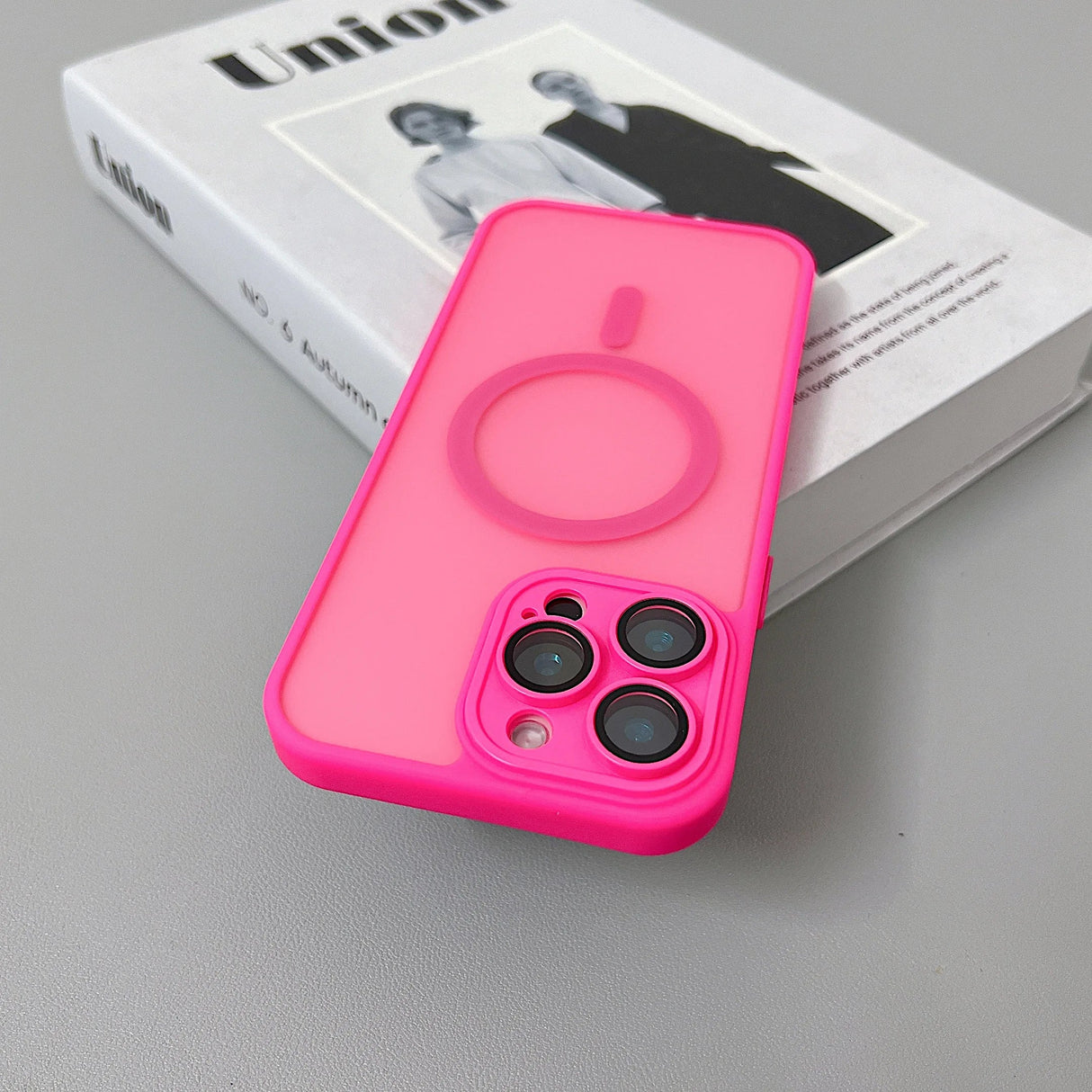 Hot pink phone case with MagSafe ring.