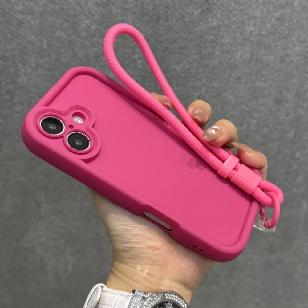 Hot pink silicone phone case with a matching wrist strap.