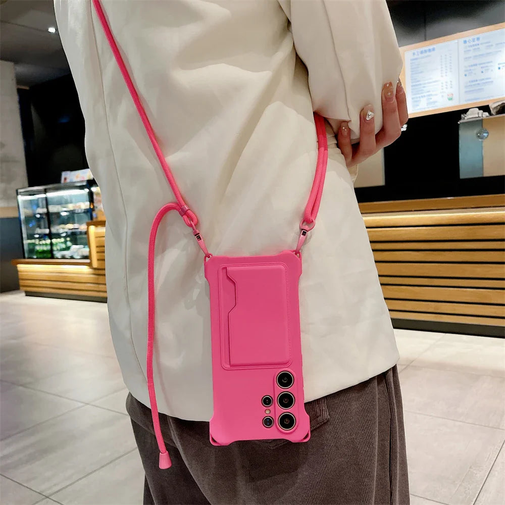 Hot pink smartphone case with a shoulder strap and card holder.