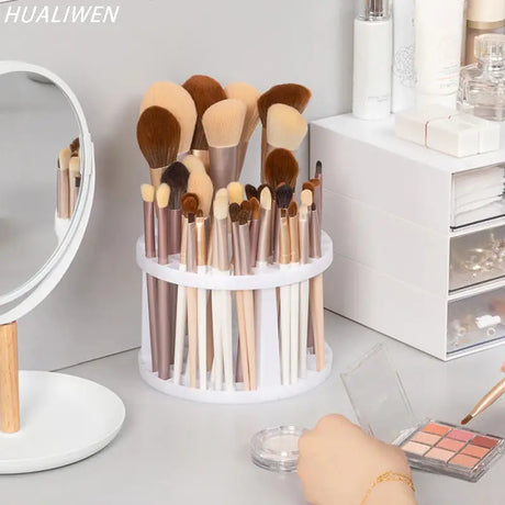a white makeup brush holder with makeup brushes and a mirror