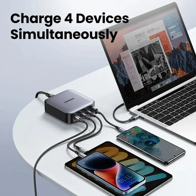 An image of a laptop, phone and charger on a table