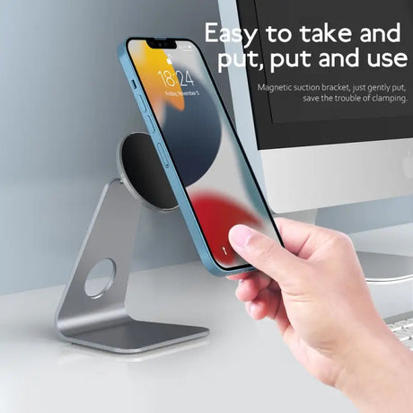 a person using an iphone to use the wireless charging station