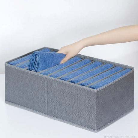 a person putting a blue cloth into a grey box
