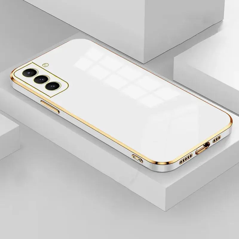 The iphone 11 is a gold case with a white back and gold sides