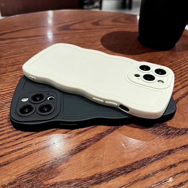 a white iphone case sitting on top of a wooden table