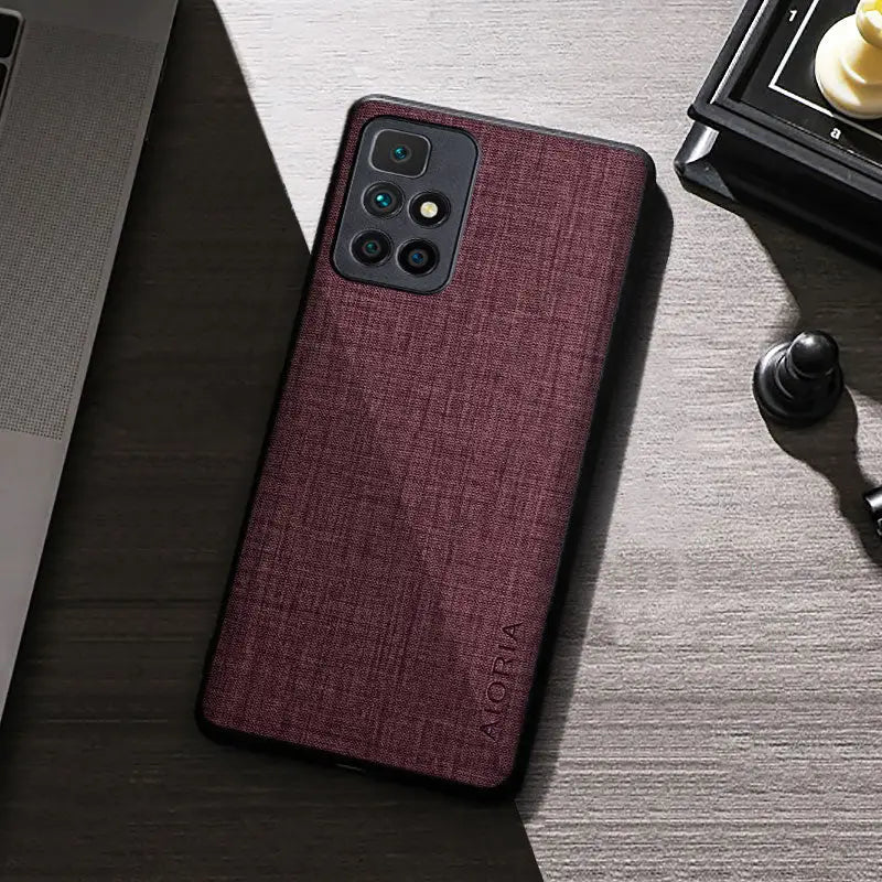 the back of a red iphone case on a desk