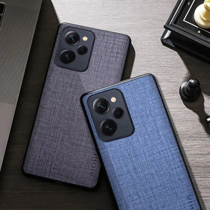 the back of a blue iphone case next to a laptop