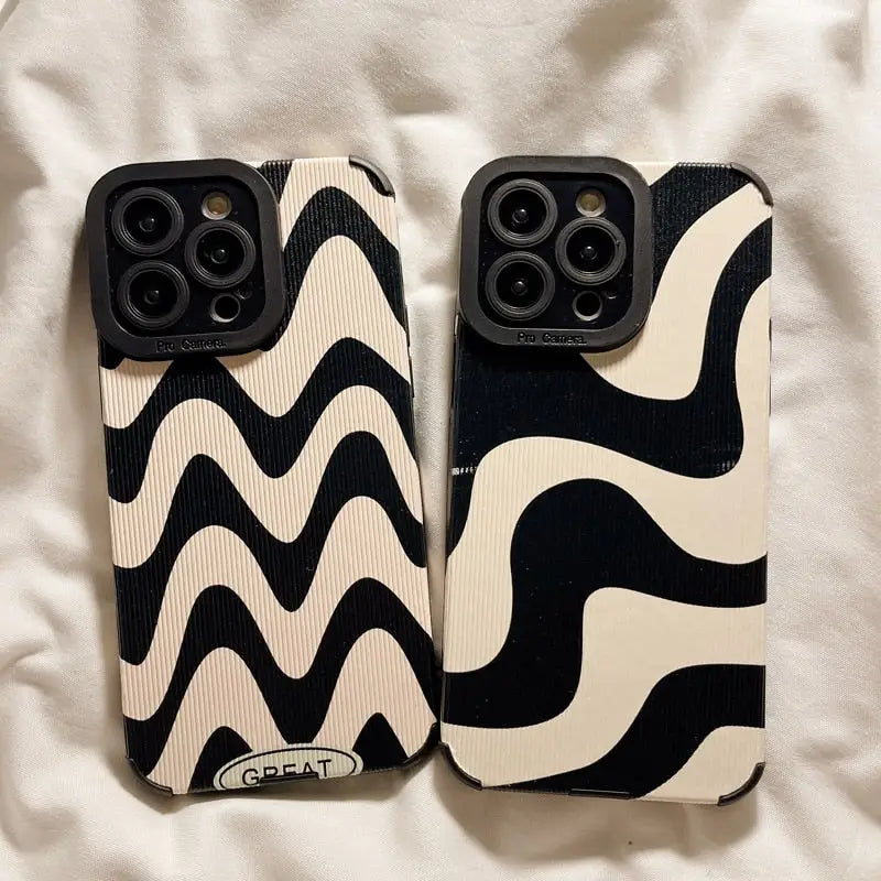 a pair of black and white iphone cases