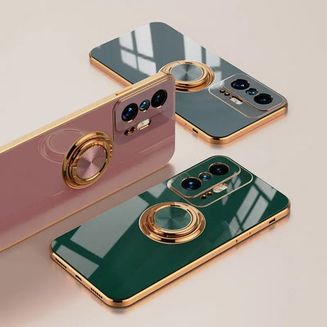 three iphones with a gold ring on them