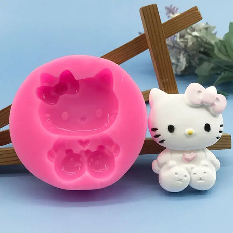 there is a hello kitty mold with a pink molder next to it