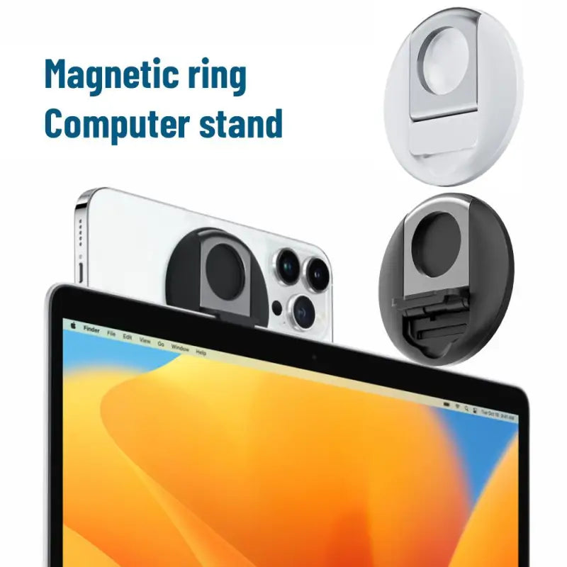 there is a laptop with a camera and a cell phone on it