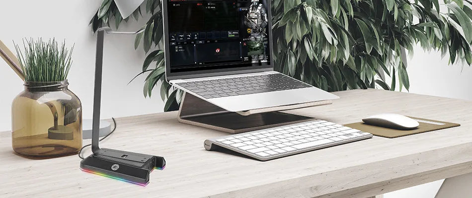 Laptop computer on a desk with peripherals and office accessories.