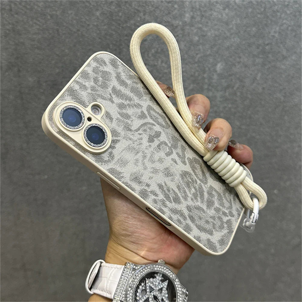 Leopard print phone case with wrist strap.