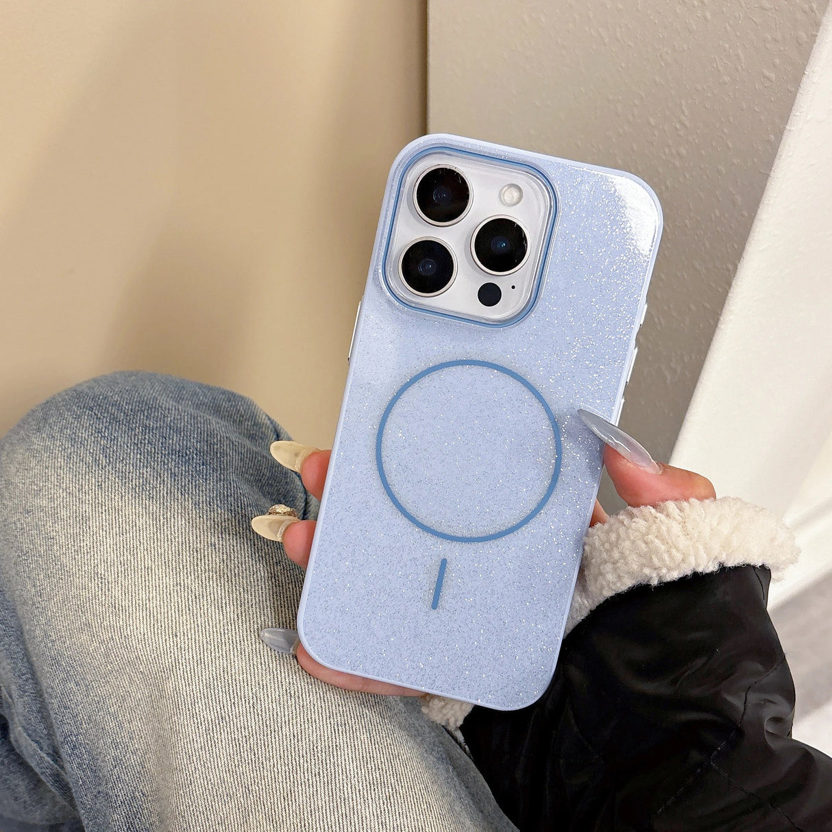 Back of a light blue glitter slim phone case with circular magnetic wireless charging pad for iphone