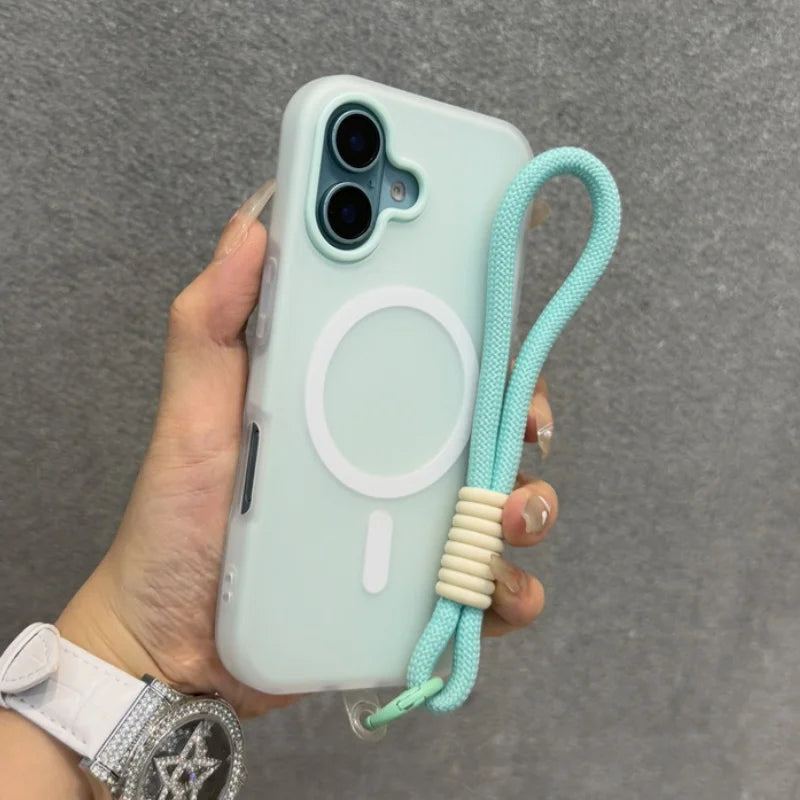 A light blue iPhone case with a white MagSafe ring and an attached mint green wrist strap with beige accents.