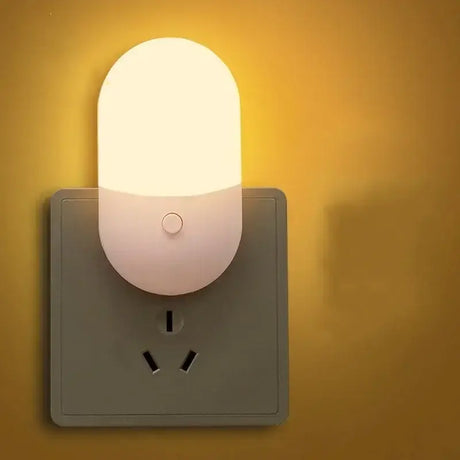 There is a light that is on the wall next to a socket
