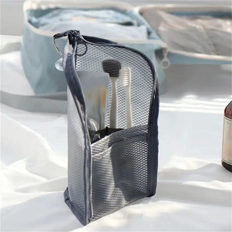 there is a bag with a bottle of wine and a toothbrush holder
