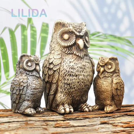 three owls figuris sitting on a log