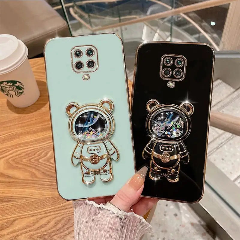 a person holding a phone case with a bear and bear