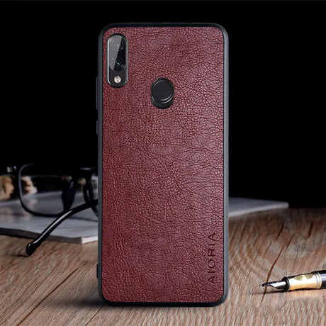 the back of a red leather case with a pen and glasses
