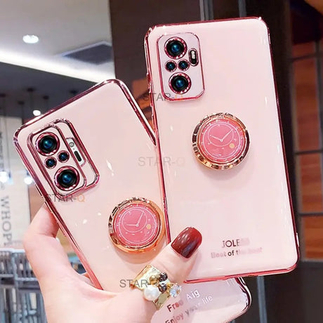 a woman holding a pink phone case with a ring