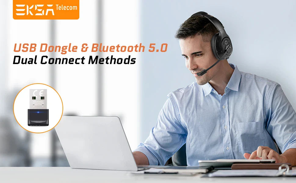 Man wearing a headset working on a laptop at a desk.