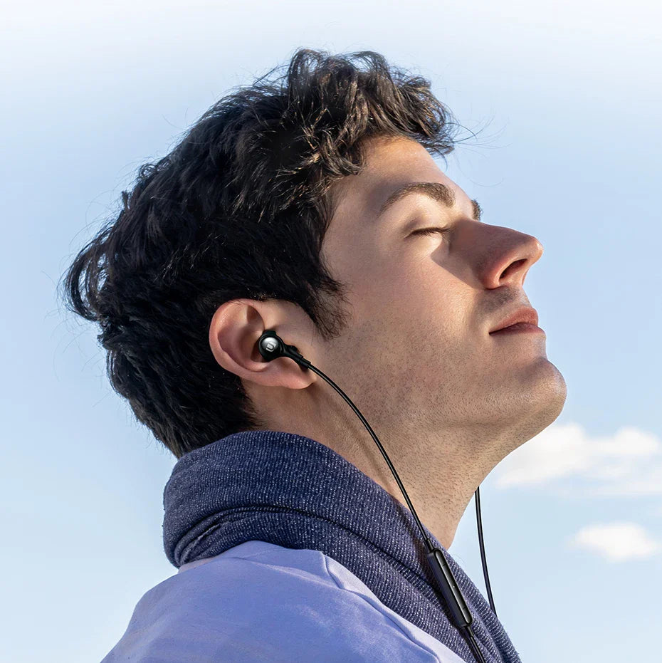 Man wearing in-ear headphones.