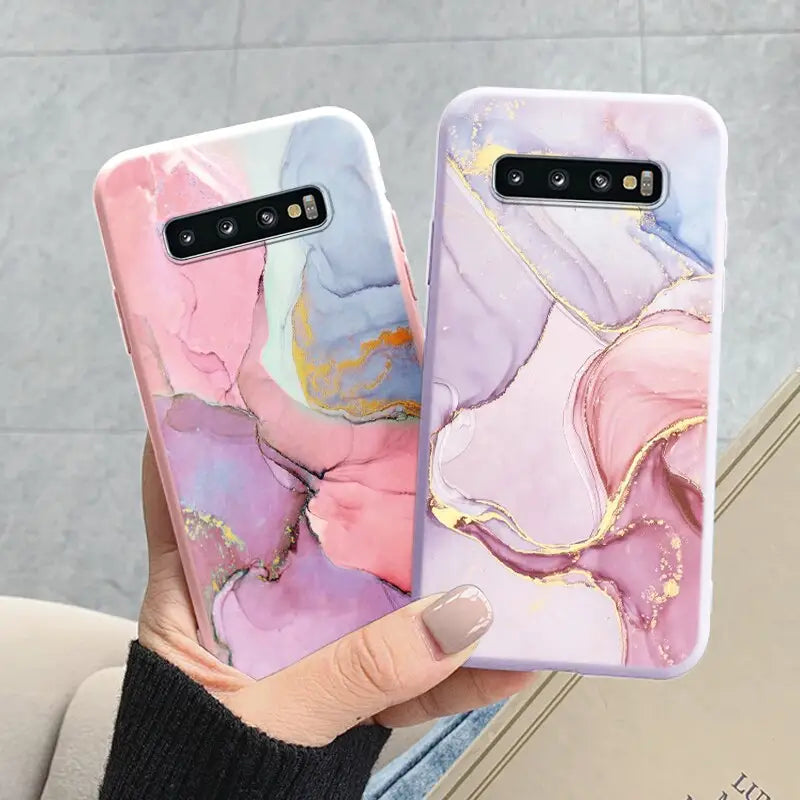 a woman holding a phone case with a marble pattern