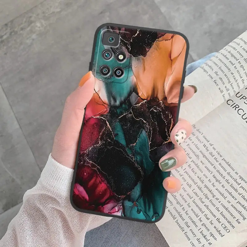 a woman holding a phone case with a marble pattern