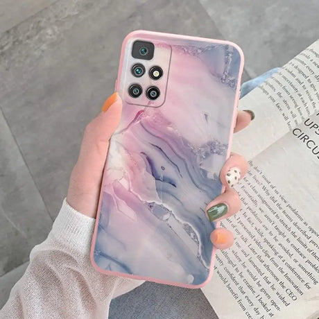 a woman holding a phone case with a marble pattern