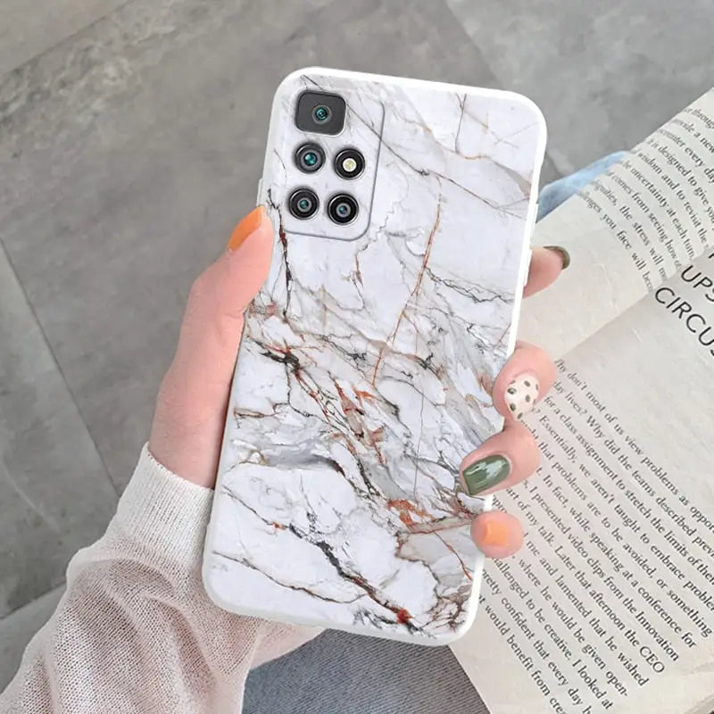 a woman holding a white marble phone case