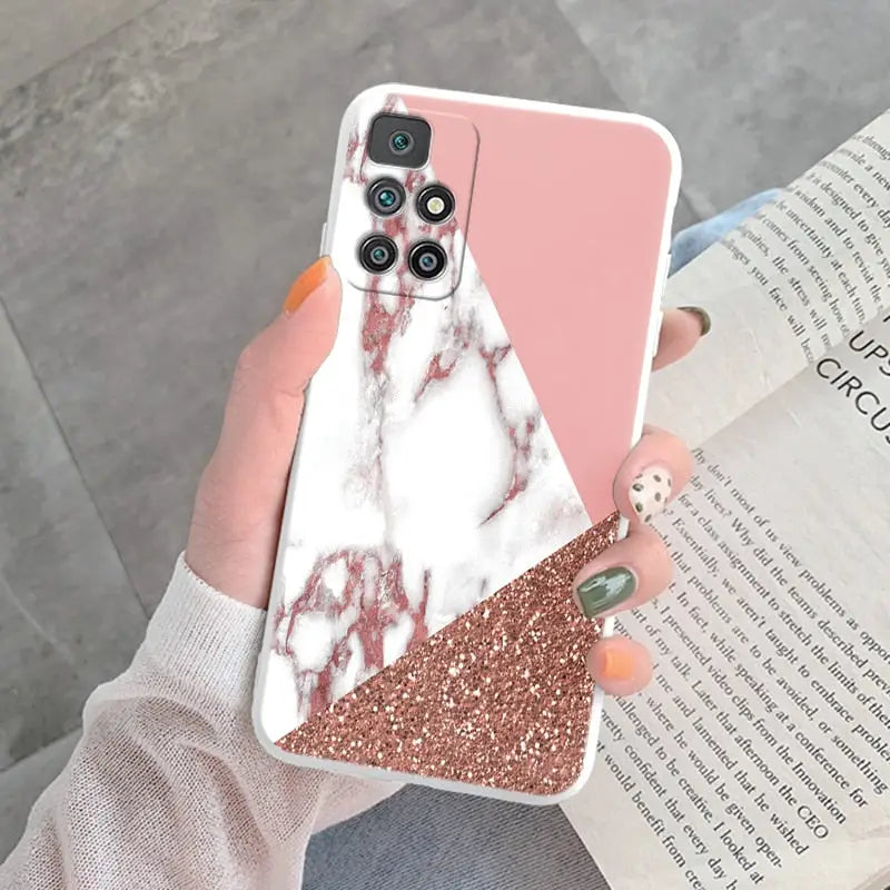 a woman holding a phone case with a pink marble pattern