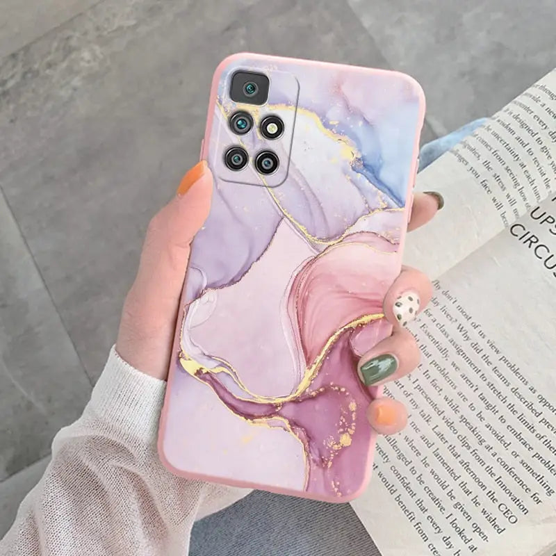 a woman holding a phone case with a marble pattern
