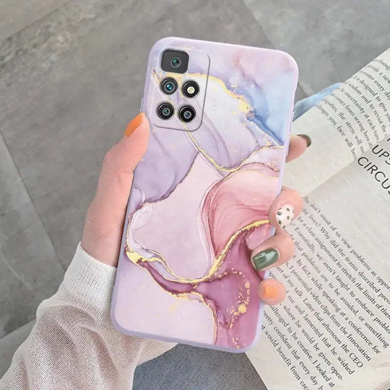 a woman holding a phone case with a marble pattern