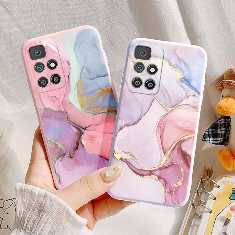 a woman holding a phone case with a painting on it