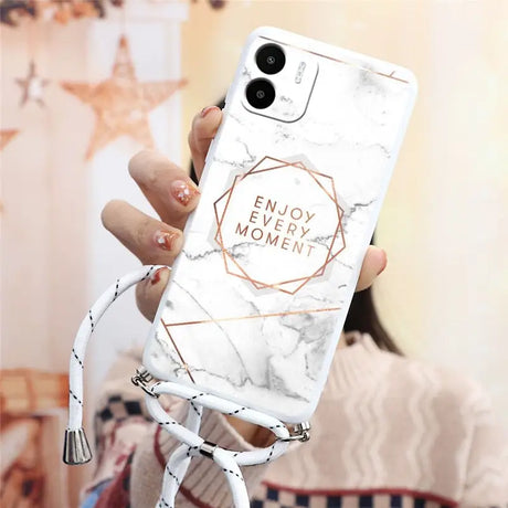 a woman holding a white marble phone case