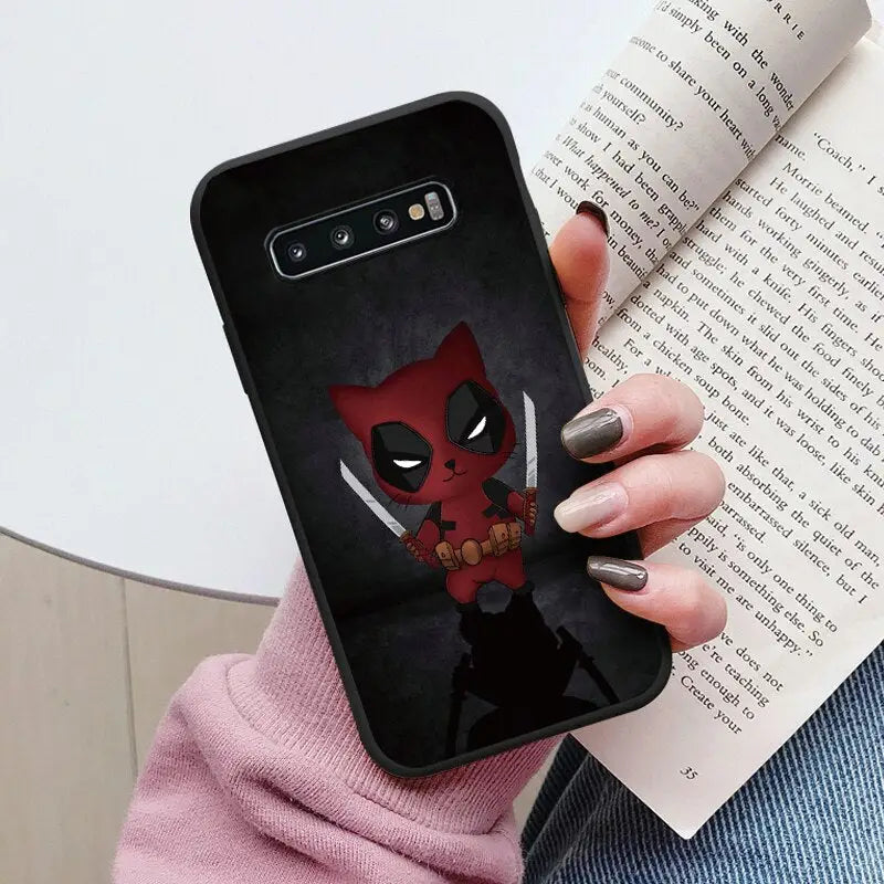 a close up of a person holding a phone case with a deadpool on it