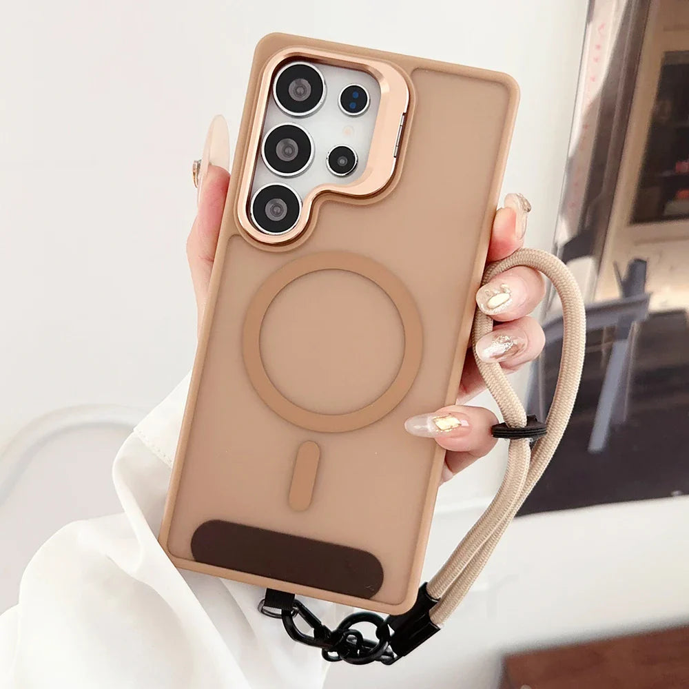 A matte beige smartphone case with a rose gold camera bezel, a built-in magnetic ring, a brown finger strap, and a beige lanyard.