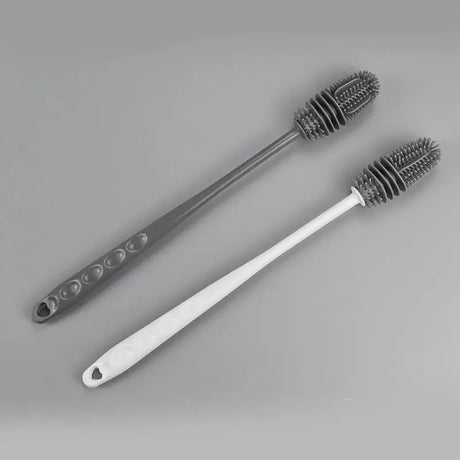 two tooth brushes on a gray background