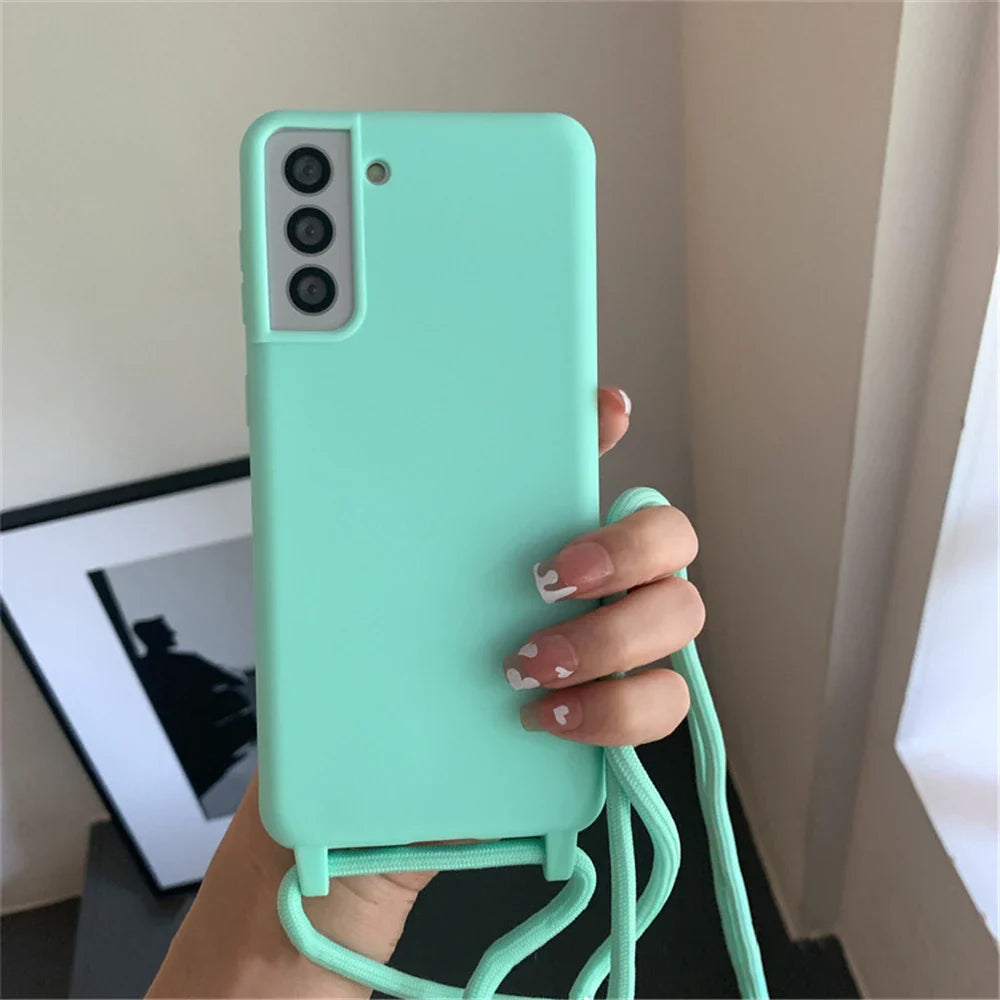 A mint green phone case with a camera cutout and an attached lanyard.