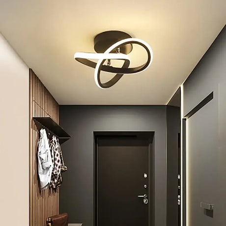 a hallway with a black door and a white wall