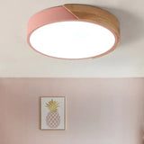 a pink ceiling light with a wooden ceiling
