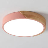 a pink ceiling light with a wooden frame