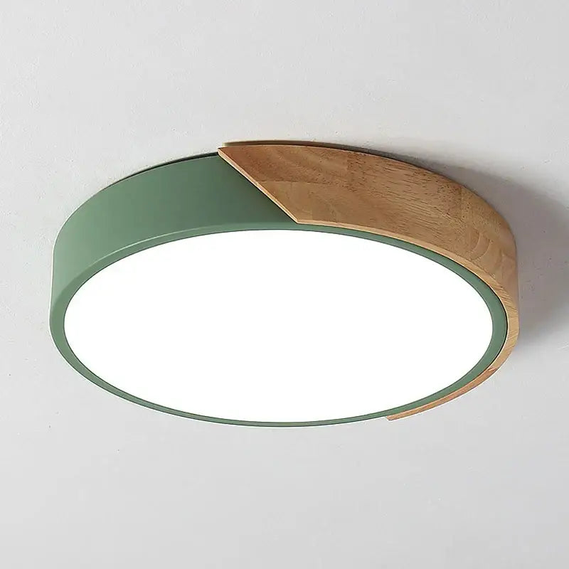 a green circular light fixture on a white wall