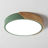 a green circular light fixture on a white wall