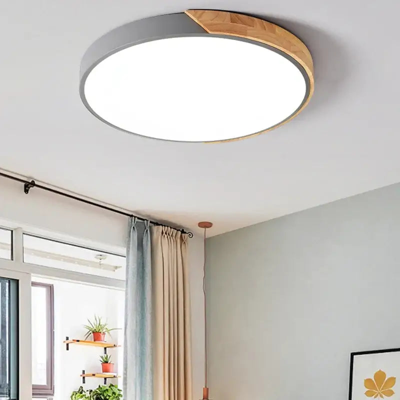 a white ceiling light with a wooden frame